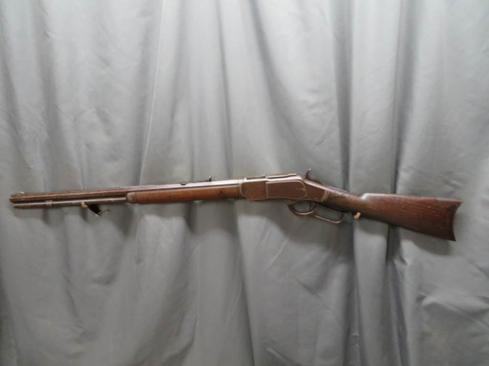 Antique Winchester Model 1873 lever-action rifle, full-length left side profile view