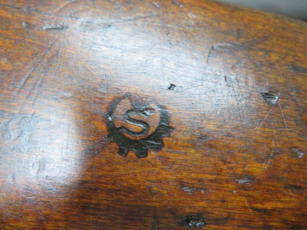 SAKO gear-wheel inspection stamp burned into the stock of a Finnish M/28-30 Mosin-Nagant rifle