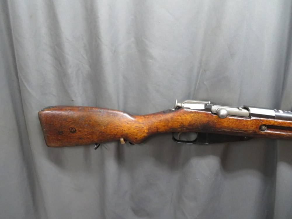 Close-up of the bolt handle, trigger, and receiver markings on a Finnish SAKO M/28-30 Mosin-Nagant rifle