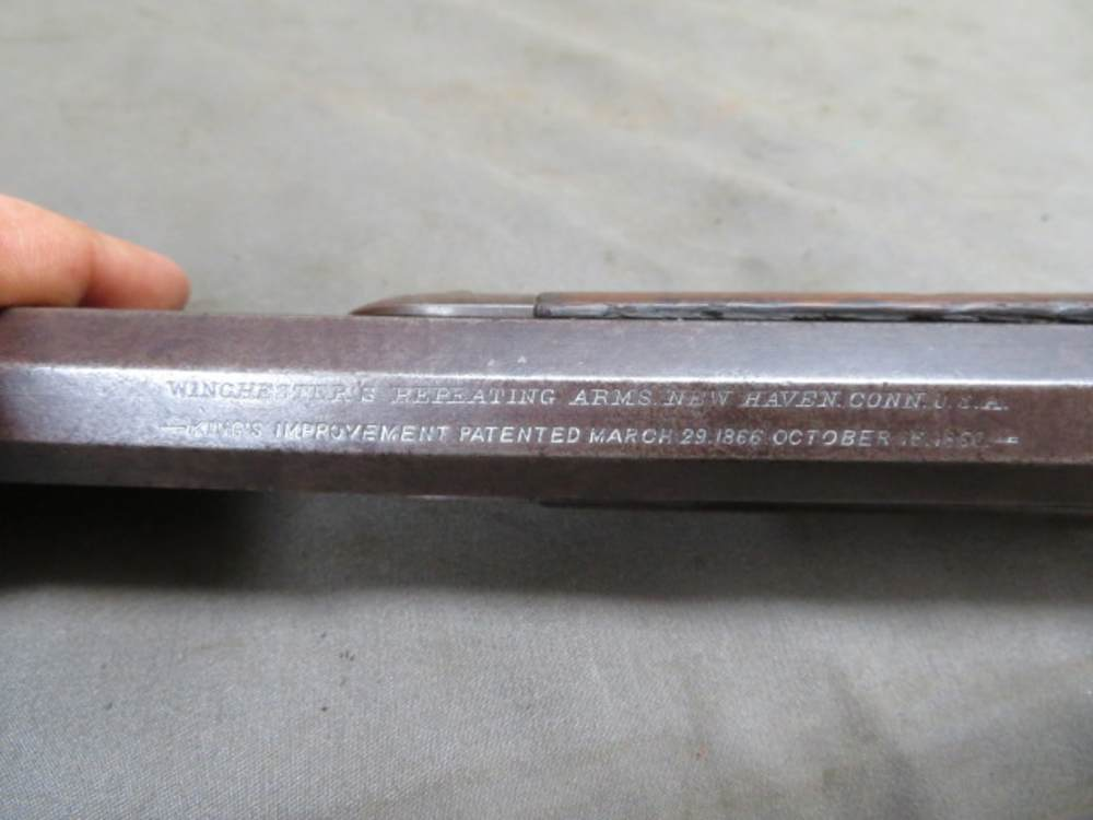Antique Winchester Model 1873 lever-action rifle, close-up of barrel address and King's Improvement patent markings