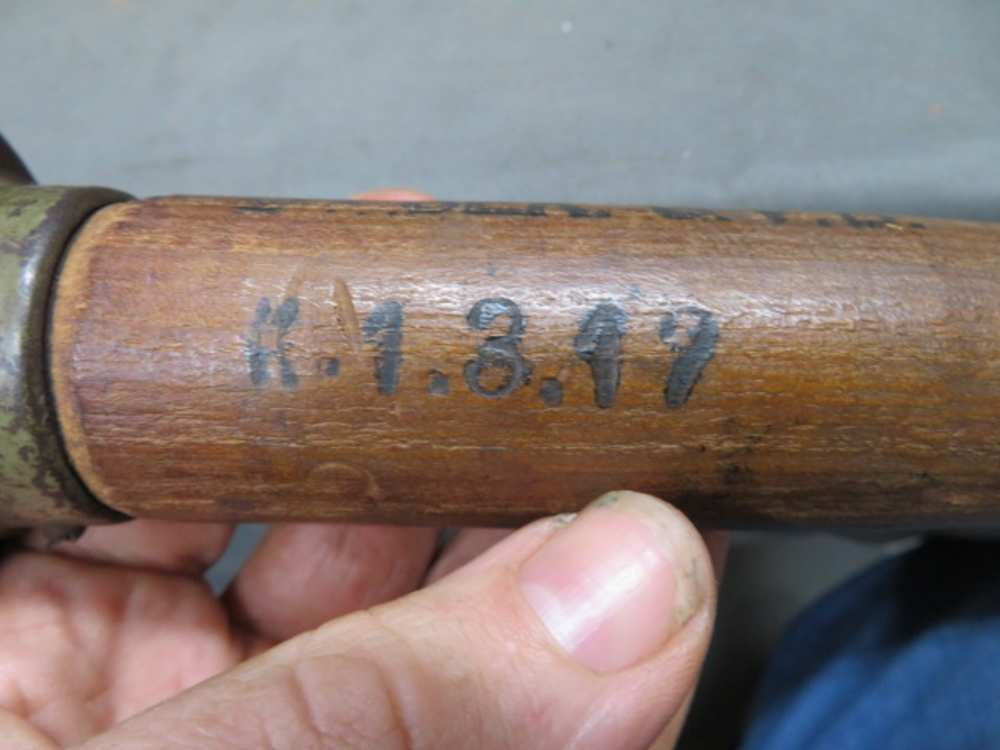 1917 date stamp on the wooden handle of a German stick grenade