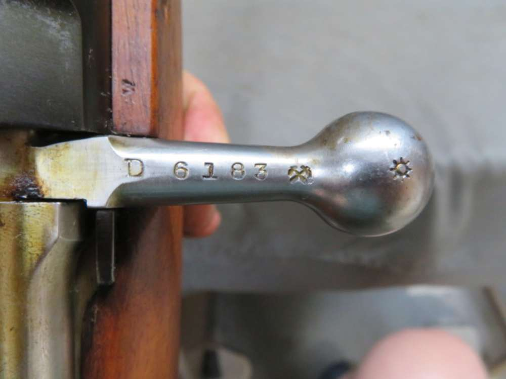 Close-up of the bolt handle and serial number