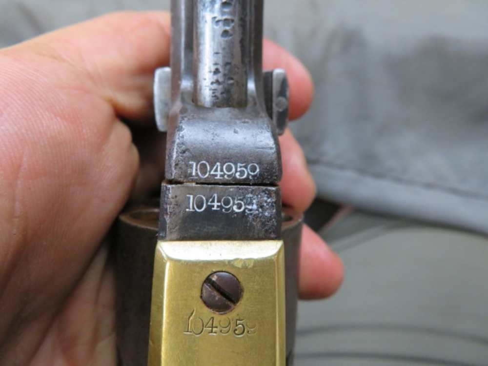 Matching serial numbers stamped on the barrel lug, frame, and trigger guard