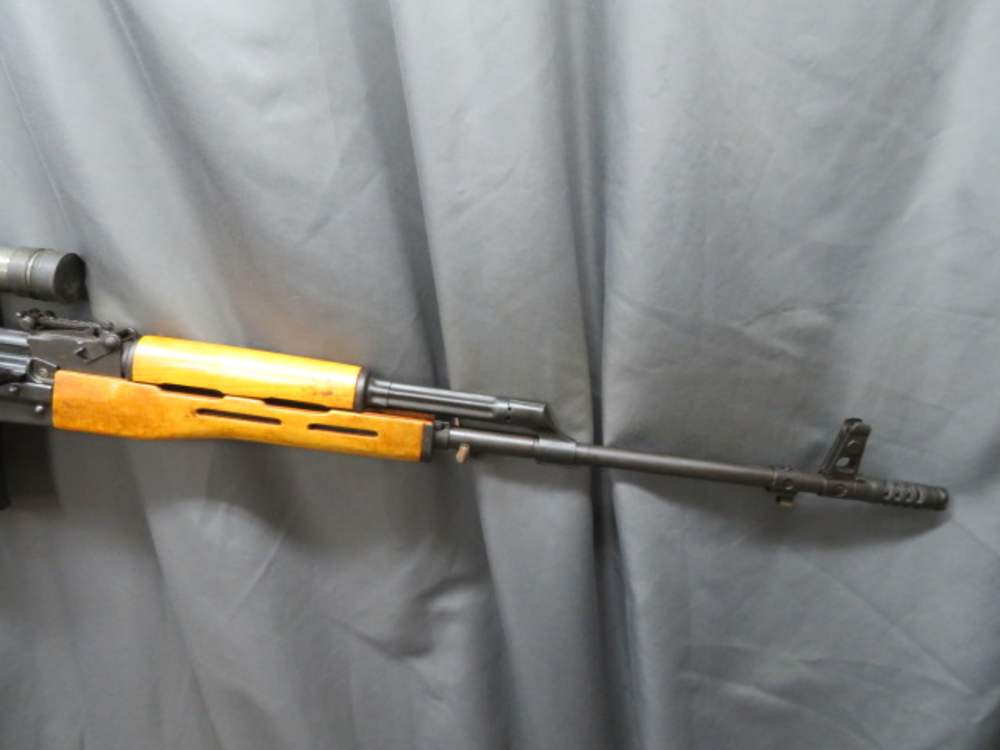 Close-up of the PSL's telescopic sight and stamped steel receiver